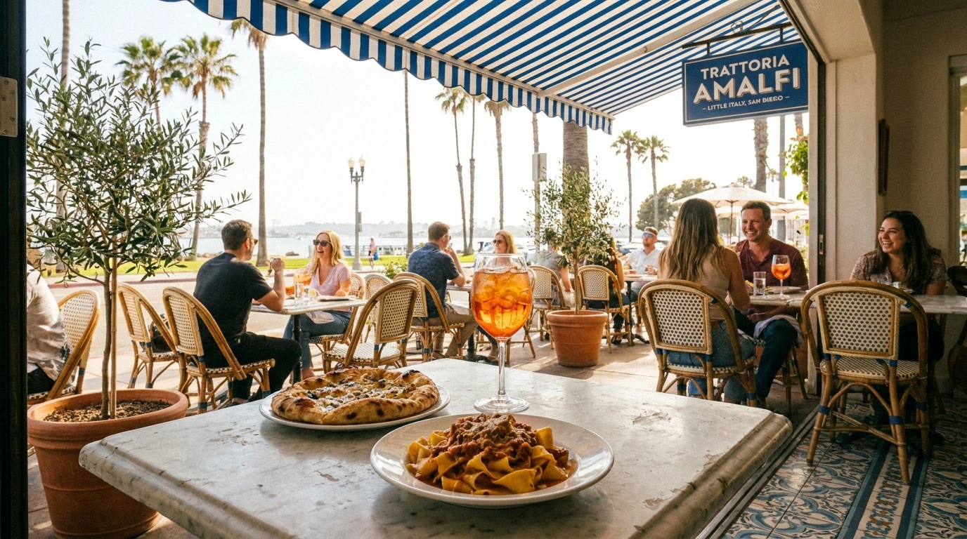 Outdoor dining scene at a trattoria, with people seated at tables, enjoying food and drinks under a striped awning, with palm trees and park visible in the background.